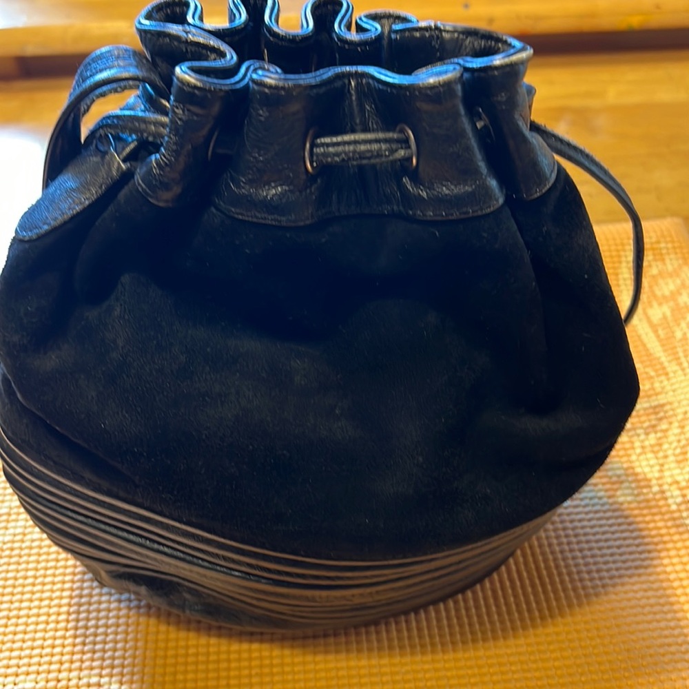 Beautiful like new Black leather & Swede drawstring bag by Toni genuine leather.